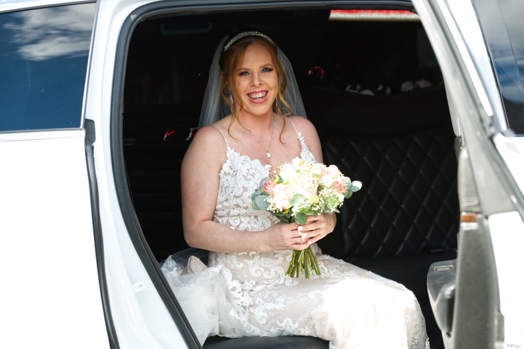 The bride getting out of her limo at the entrance of the registry office at Stockport town Hall.