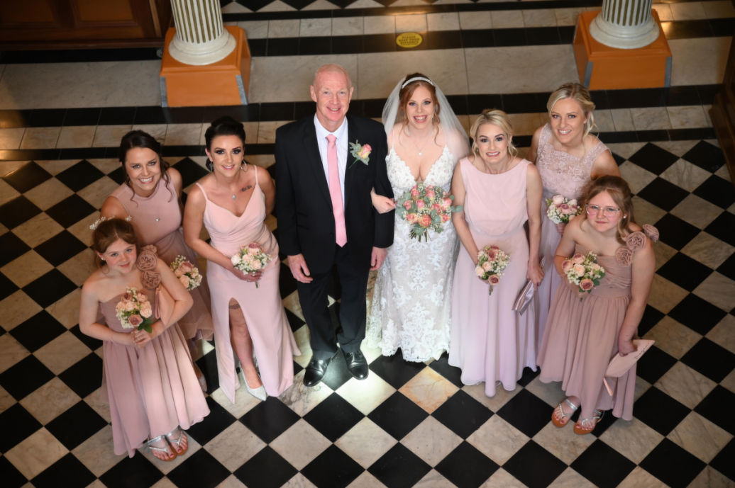 Natural wedding portrait  of the bride father and the bridesmaids outside Stockport Town Hall registry office
